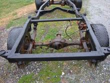 The new square tubing added and factory cross support / spare tire mount removed. The new fuel cell should fit nicely in there.