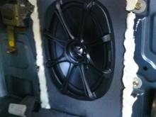 Sealed with expanding foam, speaker mounted to MDF board and re-used original mounting brackets.
