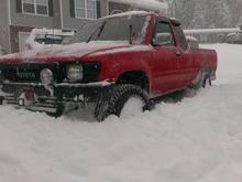 The yota makes its way threw two foot of snow.