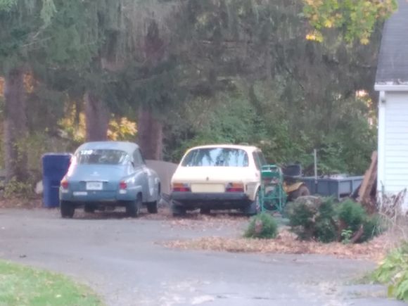 Two old SAABs One looks like a 2 stroke complete with gumball racing numbers. 