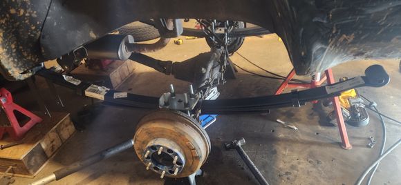 Satisfied with placement of spring in relation to axle. With the first spring tacked i could cut Ubolts on other side. Once those were cut then i could allow the pinion angle to match the first leaf spring and put ubolts on and bolt axle to it.
 Moved to other side and with the flat bars tacking the 2nd was painless.