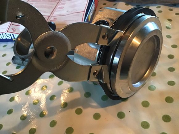 Using the ring expanding pliers to install the final ring.