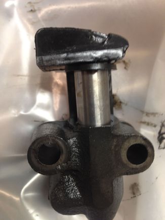 The chain tensioner note the hole in the end that guides the chain