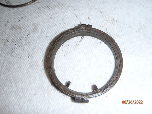 the brake spring assembly, encased by plastic/bakelite.  it is two pieces.  this is the "bottom" side, with one piece of the plastic removed.