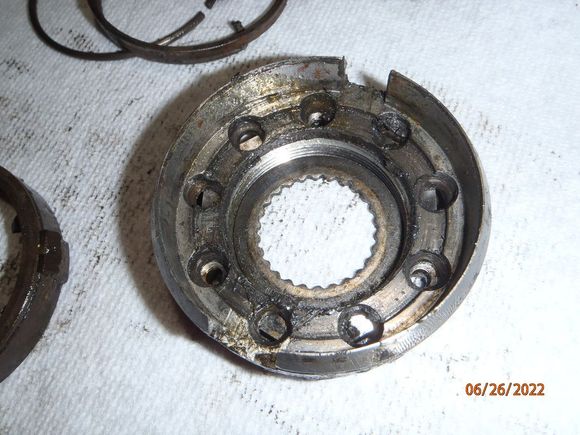 with the brake spring assembly out of the way, the lock plate can be seen.  the washer in the center can now be removed, too.  again, picture the stub shaft and spindle shaft protruding through the center.  the serrations on the washer allow it to slide onto the stub shaft splines.