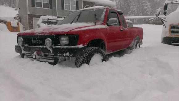 The yota makes its way threw two foot of snow.