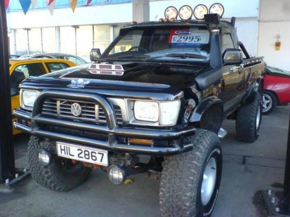 full Steel bull bar, orange running lights on the roof, sun visor, bug catcher, snorkel, rolling on a rasied 4 inch body lift &amp; 35" wheels on 15" alloys