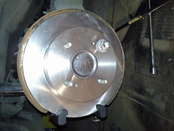 New rotor and the old caliper bracket I sanded and painted w/ Rust-oleum. Will eventually be covered with brake caliper paint.