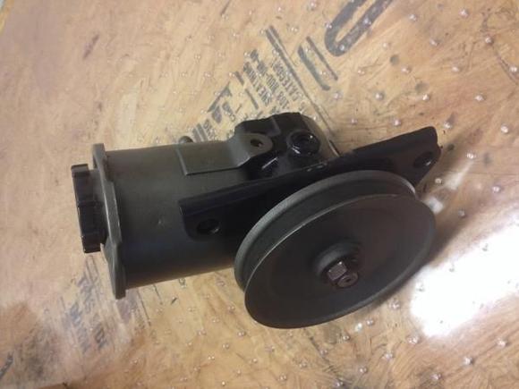 New pump ready for install. Remanufactured pump had to have all OEM hardware installed and replaced high pressure side with correct gender outlet. Sanded, primed, and painted reservoir, pulley, and mounting bracket. Good to go!